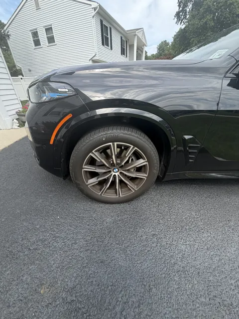 Close-up of an alloy wheel and dark front fender