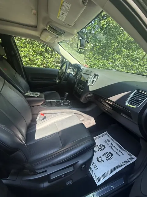 Black leather front seats viewed through the open door