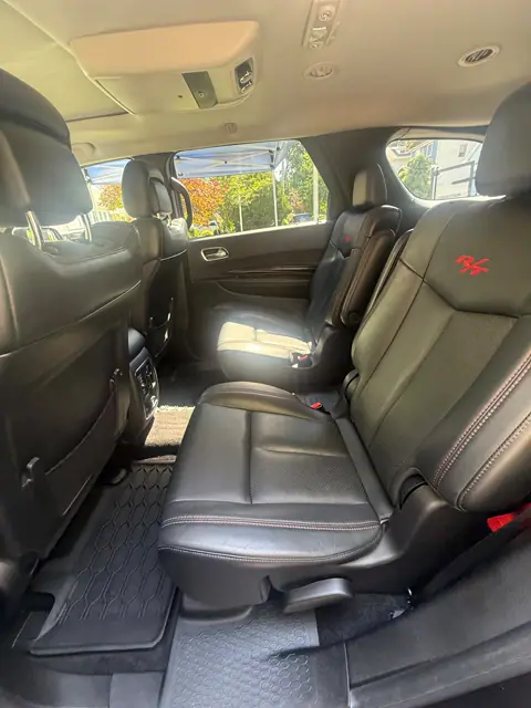Black leather second-row seats with clean dark floor mats