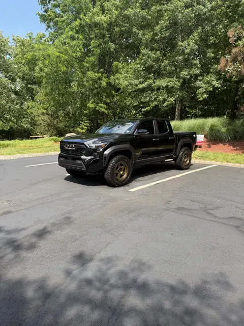 Black SUV parked in a shaded driveway
