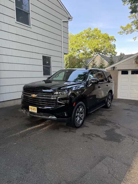 Black SUV beside a house