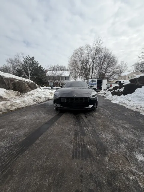 Rear view of a dark sedan on a winter street