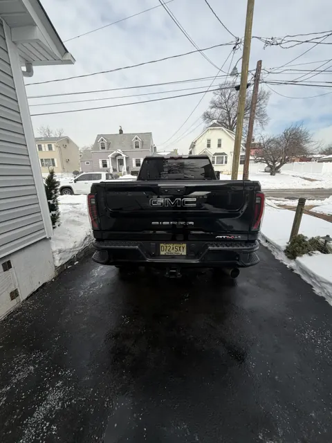 Dark pickup truck with its driver door open