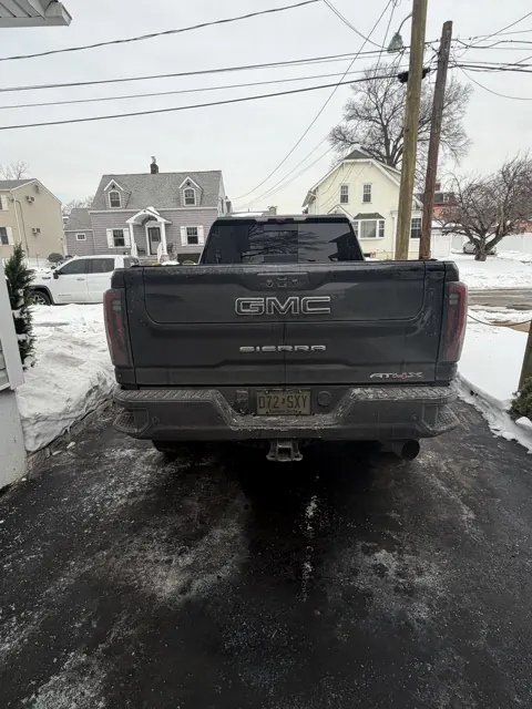 Rear view of a dark pickup truck and its tailgate