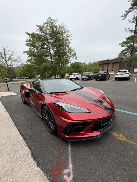 Red sports car parked at the curb
