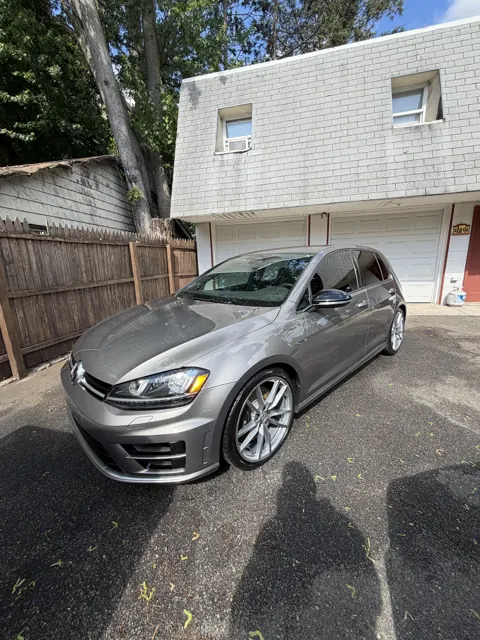 Silver hatchback viewed from the front in a driveway