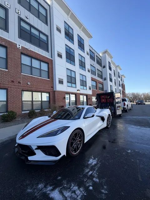 White sports car viewed from the front on a city street