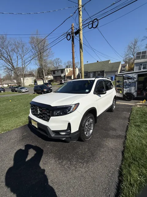 White SUV beside a residential driveway